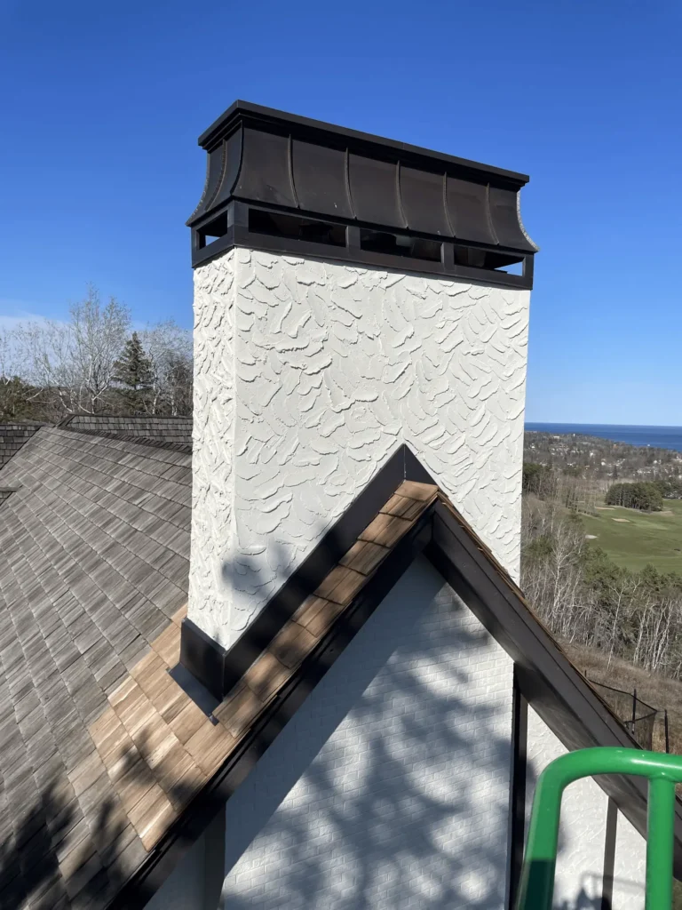 Close-up view showing the texture difference between brick and stone chimney sections