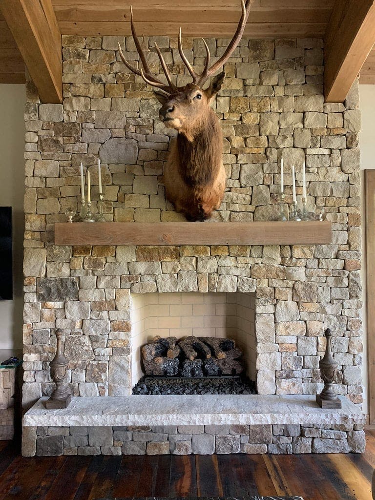 A custom stone fireplace gives both rustic and elegant vibes