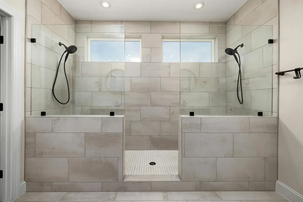 A beautiful double shower featuring custom bathroom tile installation by Royal Tile & Masonry in Duluth, MN